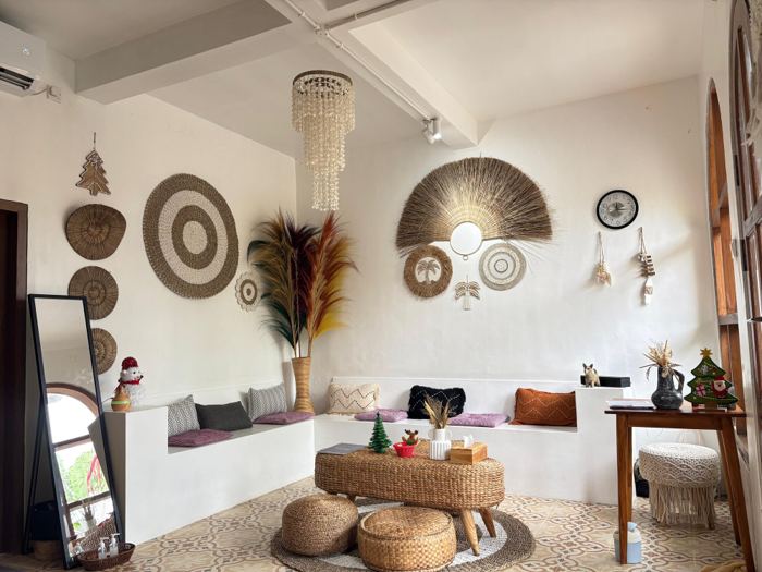 Chellvan Spa lounge with woven wall hangings, built-in seating and a rattan table