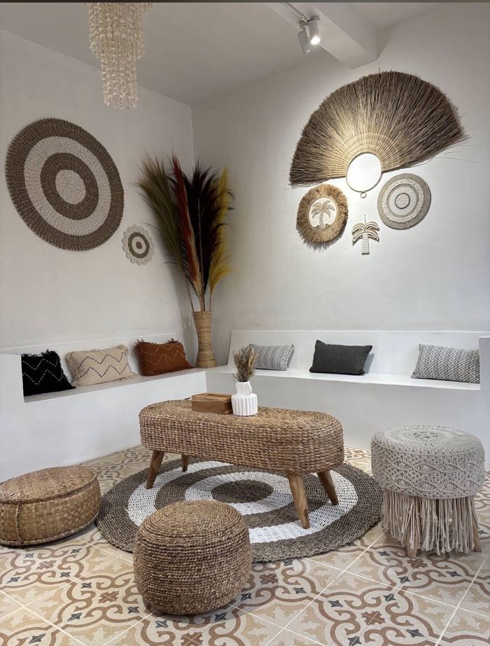 Seating corner with rattan poufs, a macramé stool and patterned floor tiles